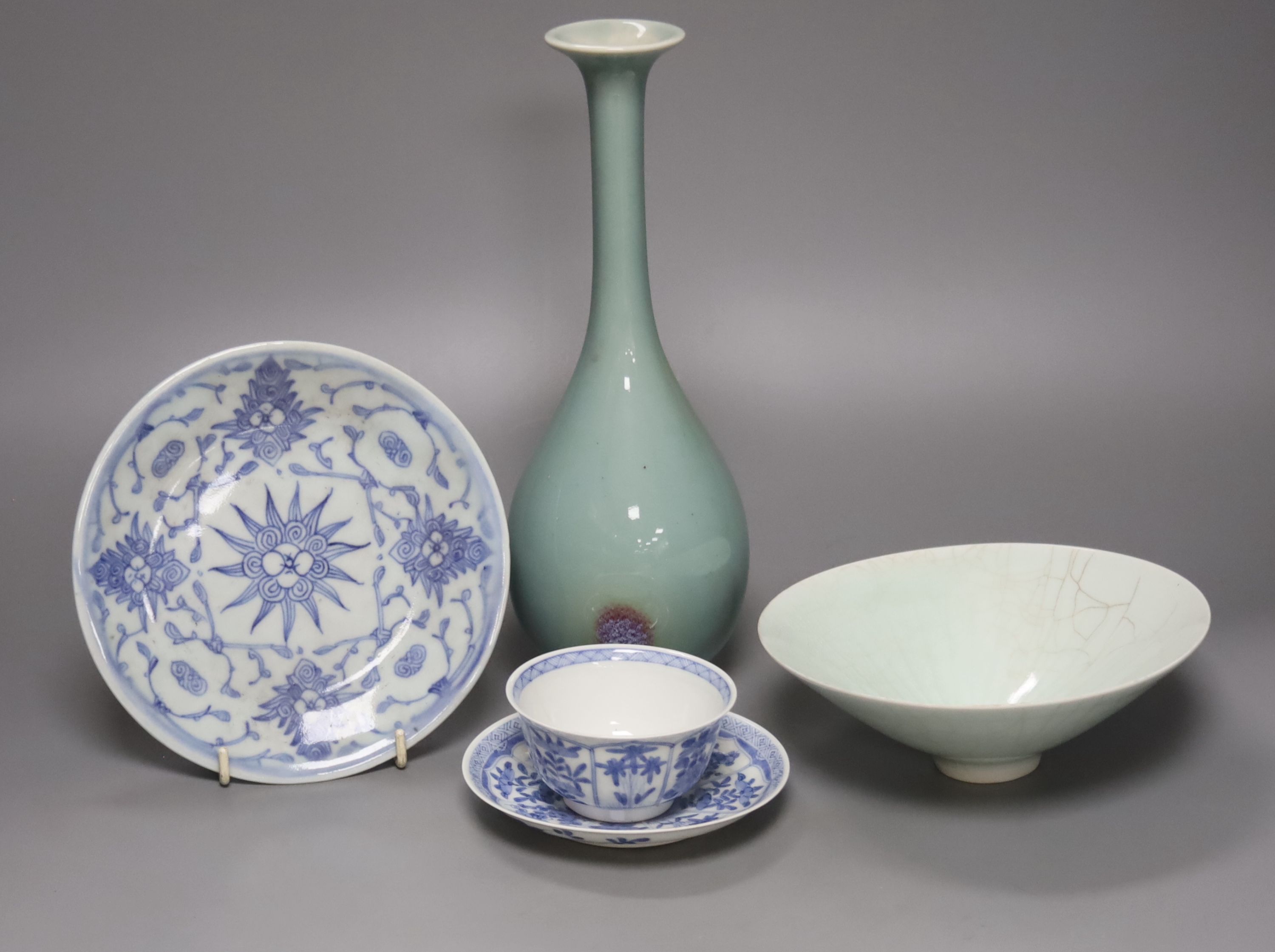 A Chinese celadon glazed vase, height 28cm, together with a crackle glaze bowl, a blue and white teabowl and saucer and a blue and white dish